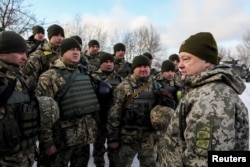 Ukrainian President Petro Poroshenko meets with soldiers during a visit to a defense post located on the contact line with Russia-backed separatists in eastern Ukraine near the rebel-held town of Horlivka in December.