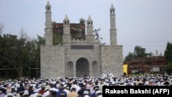Muslims take part in Eid Al-Adha prayers in Jammu, Kashmir. 