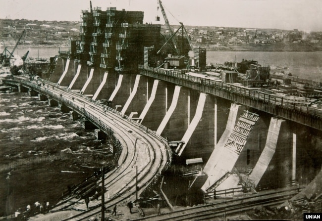 Репродукція архівного фото, на якому зображено греблю ДніпроГЕС (Дніпровська гідроелектростанція) – вид з лівого берега, в середу, 2 вересня 1931 року