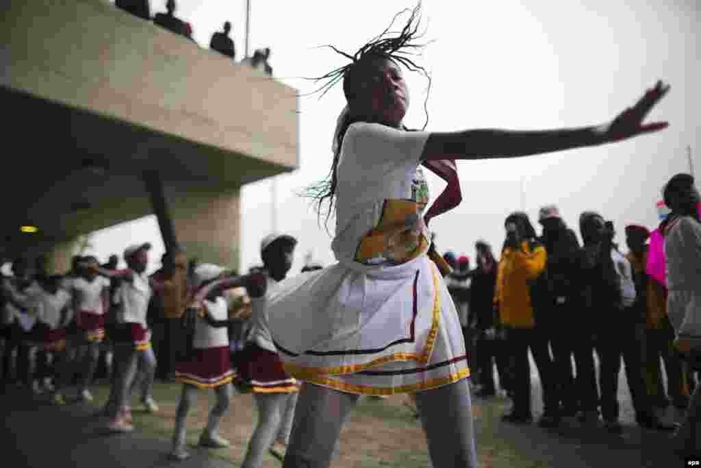 Young girls dance during the official memorial ceremony.