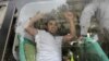 A detained Azerbaijani opposition supporter shouts inside a police bus during an antigovernment protest in central Baku on May 21 just before the Eurovision Song Contest &nbsp;was due to be held in the city. (Reuters/David Mdzinarishvili)