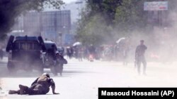 A soldier and a civilian lie low at the site of a suicide attack after the second bombing in Kabul Afghanistan on April 30.