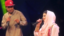 Afghan singer Zulala Hashemi (r) performs alongside competitor Sayed Jamal Mubarez (l) during the television music competition Afghan Star.
