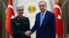 Turkish President Recep Tayyip Erdogan greets the chief of staff of Iran’s armed forces, Mohammad Baqeri, in Ankara on August 16. 