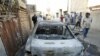 A damaged vehicle after a bomb attack in Baghdad that killed two Christians on November 10