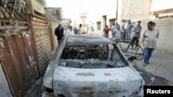A damaged vehicle after a bomb attack in Baghdad that killed two Christians on November 10