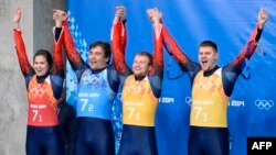 Tatyana Ivanova and Albert Demchenko (first and second left) celebrate with the silver-medal-winning Russian team during the Sochi Winter Olympics in February 2014.