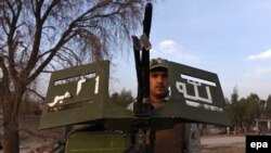 An Afghan security official stands guard at a checkpoint as security is intensified ahead of the Persian New Year, known as Norouz, in Nangarhar Province, last month.