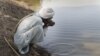A man drinks contaminated water from a stream in the Cholistan Desert, near Bahawalpur, Pakistan.