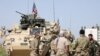 Kurdish fighters chat with members of U.S. forces in the town of Darbasiya, Syria, on April 29, 2017.