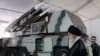 Iranian Supreme Leader Ayatollah Ali Khamenei is seen near a "3 Khordad" system which is said to had been used to shoot down a U.S. military drone, undated