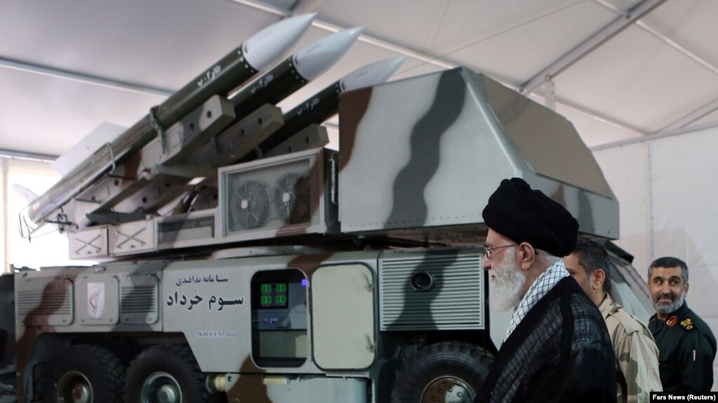 Iranian Supreme Leader Ayatollah Ali Khamenei is seen near a "3 Khordad" system which is said to had been used to shoot down a U.S. military drone, undated