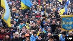 Opposition protesters shout slogans during a rally on Independence Square in Kyiv on December 13.