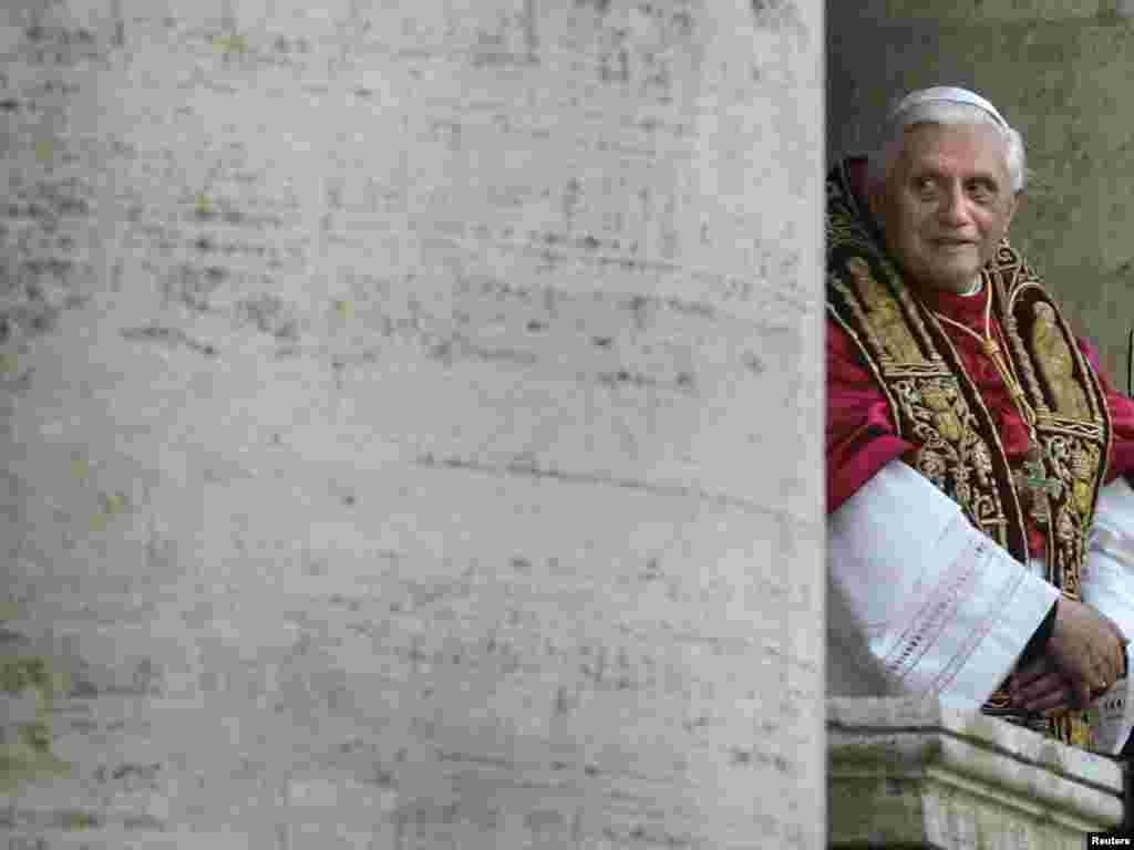 The new elected Pope Benedict XVI, known as German Cardinal Joseph Ratzinger, greets thousands of pilgrims from the balcony of the St. Peter's Basilica at the Vatican, April 19, 2005. German Cardinal Joseph Ratzinger, the strict defender of Catholic orthodoxy for the past 23 years, was elected Pope on Tuesday despite a widespread assumption he was too old and divisive to win election. REUTERS/Kai Pfaffenbach 