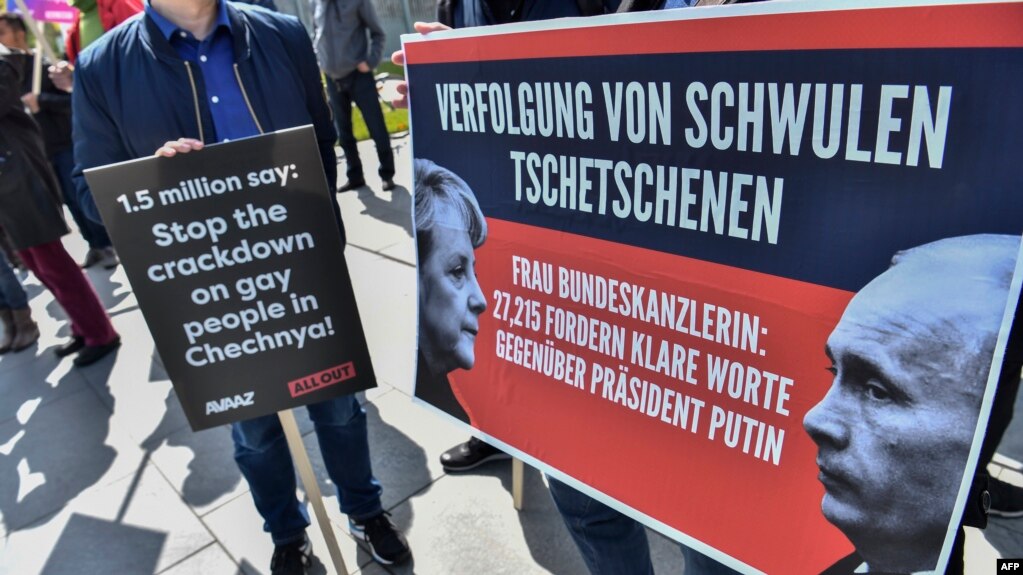 Activists display placards in front of the Chancellery in Berlin in April during a demonstration calling on Russian President Vladimir Putin to put an end to the persecution of gay men in Chechnya. The protesters called on German Chancellor Angela Merkel, who met with Putin in Sochi on May 2, to raise the issue. She said afterward that she had urged Putin to "use his influence" to end the abuse.