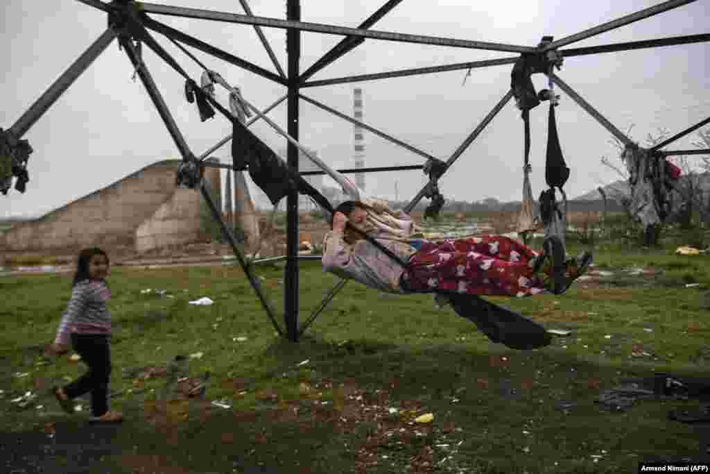 A Romany child plays on a makeshift swing in an encampment near Pristina, Kosovo. (AFP/Armend Nimani)