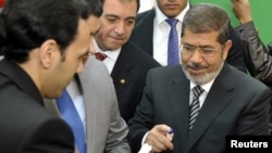 Egyptian President Muhammad Morsi voting in the constitutional referendum in Cairo on December 15.