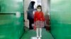 An Iranian elementary schoolgirl passes through a disinfection tunnel as she attends school in north Tehran.