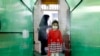 IRAN SCHOOLS PANDEMIC CORONAVIRUS COVID19 -- An Iranian elementary school girl wearing a face mask passes by a disinfection tunnel as she attends the first day of reopening the Bamdad Parsi private school, north of Tehran, Iran, 05 September 2020. Media 