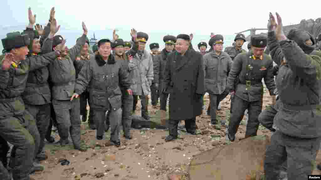 North Korea leader Kim Jong Un (center) is greeted by soldiers during his visit to a defense detachment near the border with South Korea. (Reuters/KCNA)