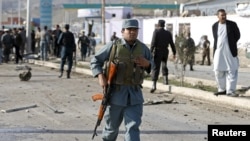 An Afghan policeman arrives at the site of a suicide attack in Kabul on April 10.