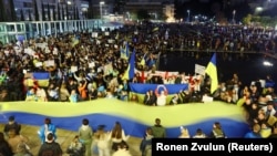 Demonstrators in Tel Aviv attend a rally in support of Ukraine after Russia launched a massive military operation against its neighbor.