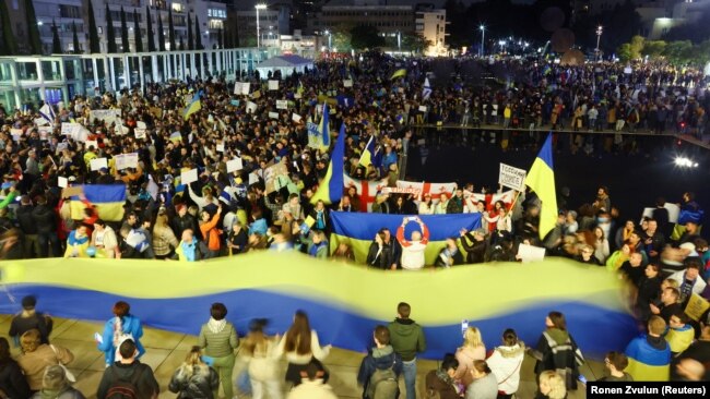 Demonstrators in Tel Aviv attend a rally in support of Ukraine after Russia launched a massive military operation against its neighbor.