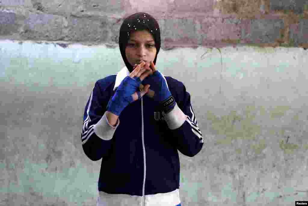 Azmeena, 16, takes part in warm up exercises.