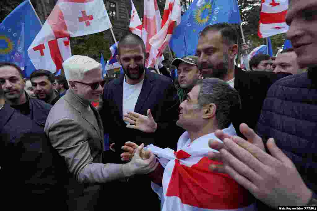 Tsotne Ivanishvili (left) and Petriashvili meet with supporters and speak to parawrestler Vakhtang Akhobadze.