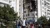 Residents assess the aftermath of a Russian drone strike in the city of Chornomorsk in Ukraine's southern Odesa region on October 8.