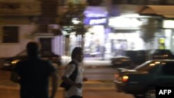 Men run for cover after unknown gunmen start shooting randomly in the flashpoint city of Homs.