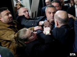 The general manager of Bulgaria's National Theater is confronted by angry protesters in Sofia on November 7.