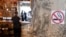 Montenegro -- A "no smoking" sign stands on a wall as a man waits at a bar counter in Podgorica, August 14, 2019