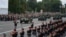 A convoy of HMMWV armored vehicles passes in front of the crowd gathered on Ștefan cel Mare Boulevard, while the military band plays as the parade proceeds.