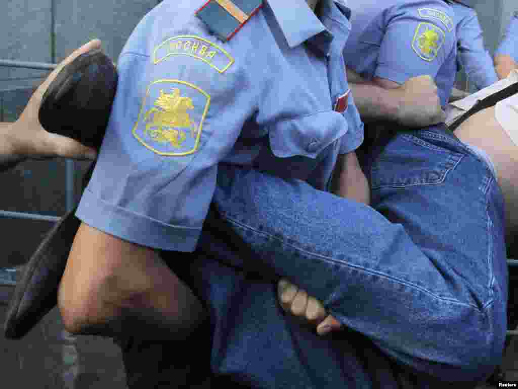 Policemen detain an opposition activist during a demonstration in central Moscow on August 12. Opposition supporters held an unauthorized rally dubbed the "Day of Wrath" and demanded the resignation of Moscow Mayor Yury Luzhkov. Photo by Denis Sinyakov for Reuters