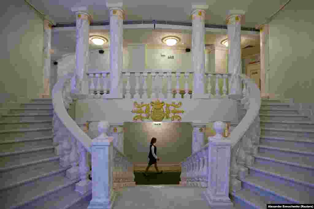 A woman walks through the facility on the night of the reopening ceremony. The building has been fundamentally changed during the rebuild, in which the ruined theater was razed nearly to the ground.