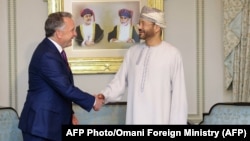US special envoy Steve Witkoff shakes hands with Oman's Foreign Minister Badr bin Hamad al-Busaidi in Muscat today.