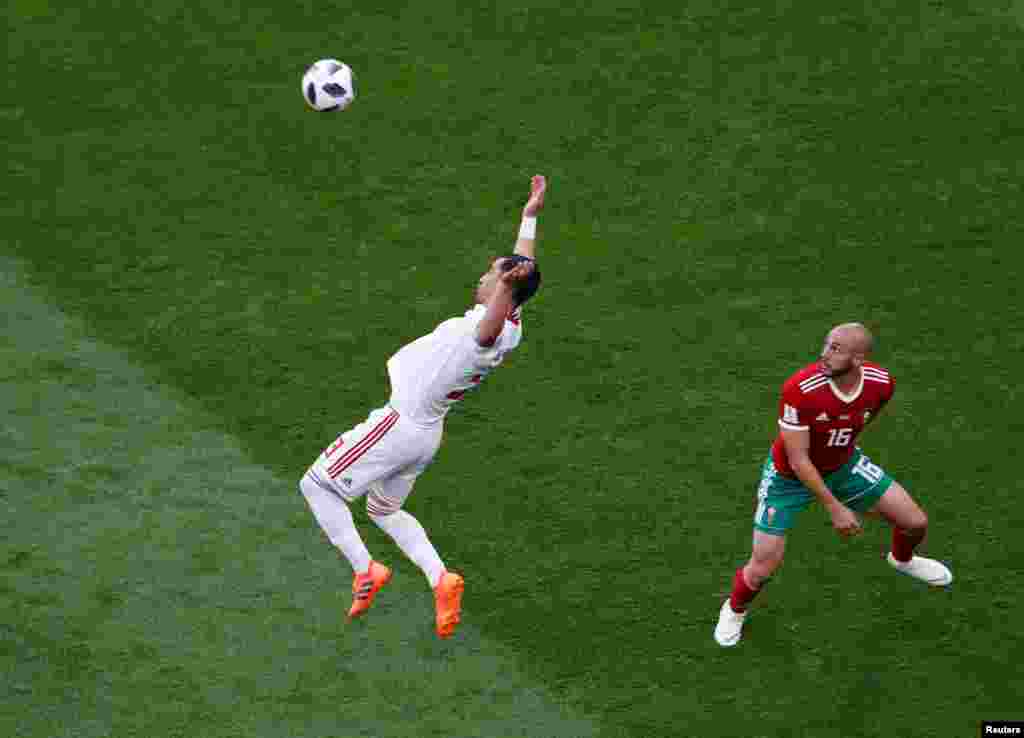 Soccer Football - World Cup - Group B - Morocco vs Iran - Saint Petersburg Stadium, Saint Petersburg, Russia - June 15, 2018 Iran's Ehsan Hajsafi in action with Morocco's Nordin Amrabat REUTERS/Lee Smith