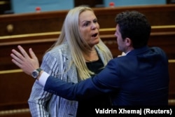 Deputetja Time Kadrijaj. Kurti më pas tha se nuk ankohet për këtë aksion të deputetes së Aleancës, nëse ky është "çmimi" që duhet të paguajë që partitë të arrijnë një marrëveshje.