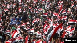 Supporters of Shi'ite cleric Muqtada al-Sadr wave Iraqi flags during a rally in Basra on March 19.