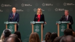 Ireland's prime minister Michael Martin (left) and other government ministers speak to during a press conference to launch the program of the Irish EU presidency in Dublin on June 10. 