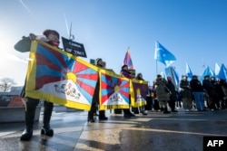 Tibetan and Uyghur activists stage a protest outside the United Nations in Geneva during the review of China's rights record by the UN Human Rights Council on January 23.