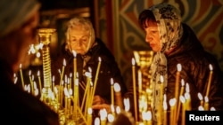Ukrainians light candles during a service ahead of Orthodox Easter at St. Michael's Cathedral in Kyiv on April 11. 