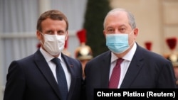FRANCE - French President Emmanuel Macron, wearing a protective face mask, welcomes Armenian President Armen Sarkissian for a meeting at the Elysee Palace in Paris, France, October 22, 2020