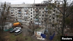 Hitne službe na mestu udara drona u stambenu zgradu u Kijevu, 23. decembar 2025.