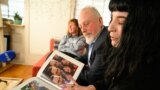 Mikhail and Danielle Gershkovich, father and sister of detained journalist Evan Gershkovich, look at photos of Evan in her wedding album at Danielle's apartment in Philadelphia on February 27.