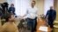 Pyotr Ofitserov (left) and Aleksei Navalny (center) appear in a Kirov court on February 8.