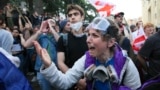 A demonstrator argues with police officers during an opposition protest against the "foreign agent" law outside the parliament building in Tbilisi on May 28. 