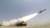 A missile is fired out to sea from a mobile launch vehicle reportedly on the southern coast of Iran along the Gulf of Oman during a military exercise, June 17, 2020