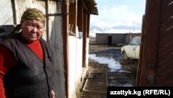 A woman surveys flood damage in Kyrgyzstan's Naryn region on March 29.